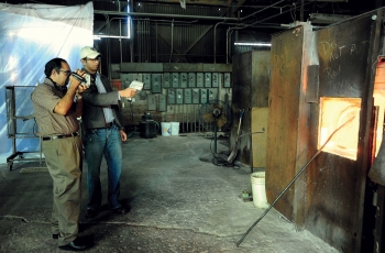 Gopala and a student conduct an energy assessment on a glass-melting furnace.<br /><em>Courtesy of WVU</em> Gopala and a student conduct an energy assessment on a glass-melting furnace.<br /><em>Courtesy of WVU</em>