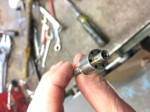 Waste feed nozzle atomizes and sprays the liquid waste