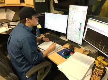 An operator works on the facilityâs distributed control system.