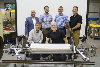 Front row, left to right, Jud Lilly and Red Whittaker; back row, left to right, Jean P. Pabon, Bryan Steinfeld, Richard Mayer, and Kyle Gjersvold. Participants in the Carnegie Mellon University (CMU) demonstration gather behind PipeDream.