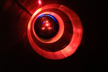 PipeDream measures the volume of surrogate deposits while spiraling sensors through a test pipe. Its headlights alternate white and ultraviolet to acquire the visual and fluorescent appearance of the surrogate deposits.