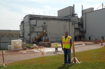 CH2M HILL BWXT West Valley Facility Disposition Project Operations Manager Scott Chase was hired to test the pumping system used to transfer high-level waste from the siteâs underground tanks to the Vitrification Facility, pictured in the background.