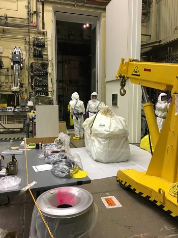Workers are removing wiring, cables, and other large abandoned equipment from the airlock of the Hanford Siteâs 324 Building.