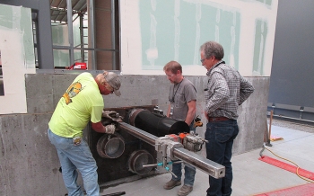 Workers are drilling holes into the concrete walls of a training facility that simulates a hot cell in the 324 Building. The holes will be used to install remotely operated equipment for worker testing and training.