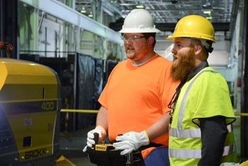 Fluor-BWXT Portsmouthâs Tim Cline, left, works with a remote while receiving direction from Brokkâs Jessie Love.