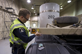 Idaho State Patrol Commercial Vehicle Safety Officer Richard Stouse inspects the first shipment of contact-handled transuranic waste to go to the Waste Isolation Pilot Plant since the facility reopened in January.