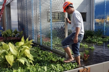 A man walks barefoot through a garden
