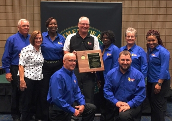 Savannah River Nuclear Solutions (SRNS) employees pose with DOE Office of Worker Safety and Health Assistance Director Brad Davy after receiving the companyâs 16th DOE-Voluntary Protection Program Star of Excellence award.