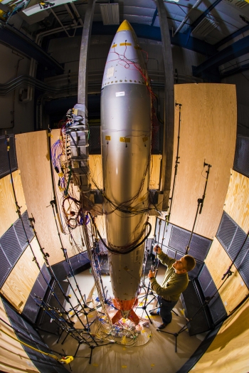 Sandia National Laboratory mechanical engineer Ryan Schultz adjusts a microphone for an acoustic test on a B61
