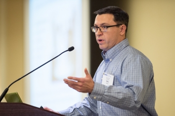 Photo of a man presenting at a conference