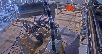 The robotic snake arm uses compressed air to move simulated high-level waste called calcine during a mockup demonstration.