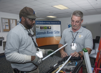 Personnel from Universal Supplies and Services, a small business subcontractor to Savannah River Nuclear Solutions, perform work in a non-nuclear facility.
