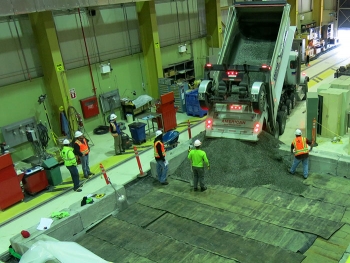 Workers with CH2M HILL Plateau Remediation Company subcontractor Ojeda Business Ventures construct a test pad to evaluate a floor saw to remove highly contaminated soil from beneath a former research building on the Hanford Site.