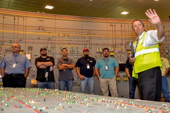 EM Paducah Site Safety Systems Oversight/General Engineer Brad Pont leads Atomic Energy Workers Council members through the C-300 Building.