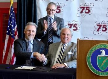 Left to right, Ken Rueter, Jay Mullis Warren Gooch sign an agreement enabling UCOR to construct the K-25 History Center inside the second floor of the city-owned East Tennessee Technology Park fire station.