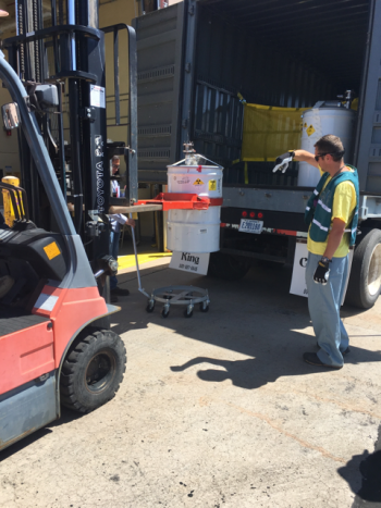 Workers carefully transported the RNS drums from the climate-controlled steel enclosure in Area G to WCRRF.