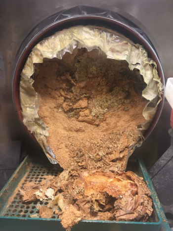 The RNS drums were safely secured to the glovebox at WCRRF before they were treated.
