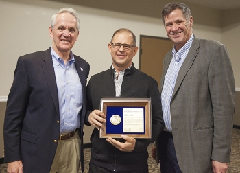Accelerated Retrieval Project IX Federal Project Director Nolan Jensen, center, receives the EM Federal Project Director of the Year Award at the 2017 Contract, Project and Program Management Workshop.