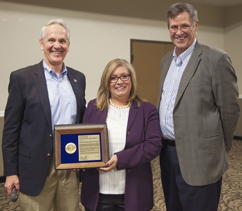 Soni Blanco, SRS senior technical program manager for planning and integration, center, accepts the EM Project of the Year Award on behalf of Salt Disposal Unit 6 Federal Project Director Jean Ridley.