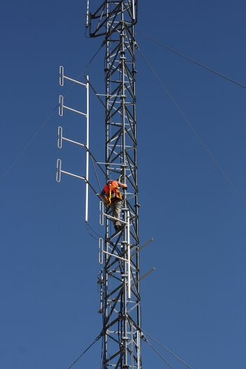 A worker inspects a tower on the 100-foot Gable Mountain East Telecommunications Tower on the Hanford Site.