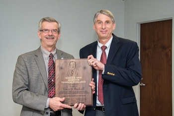 Savannah River National Laboratory Director Dr. Terry A. Michalske (left) awards Tracy S. Rudisill the 2017 the Donald Orth Lifetime Achievement Award, the highest honor given by the laboratory for technical excellence and leadership.