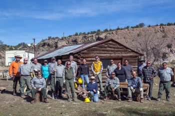 Participants at an NPS preservation workshop take a break from their work on the Pond Cabin, part of MAPR in Los Alamos, New Mexico.