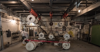 A worker looks at reactor components that were once part of an experimental laboratory area. By entering the K East Reactor now, workers can help a planning team understand current conditions and establish future safety controls and work processes.