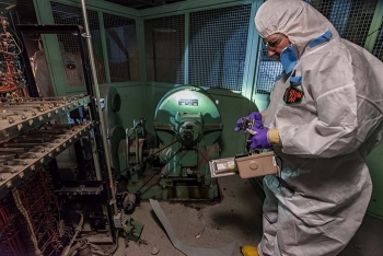 Workers use specialized equipment to monitor and document potential contamination.