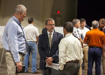 Nuclear Waste Partnership (NWP) President and Project Manager Bruce Covert talks with participants attending the Waste Isolation Pilot Plant Industry Day who learned about doing business with EMâs Carlsbad Field Office and NWP.