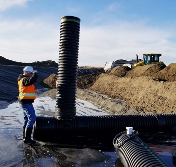 Work is underway to install drain pipes in a large basin that will collect and evaporate water drained from interim surface barriers to be constructed over underground waste tanks at Hanford.