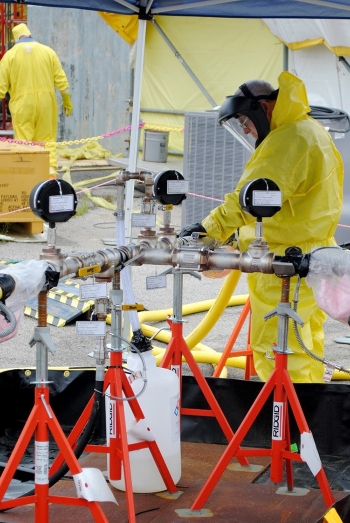 Savannah River Remediation operations employees safely re-wet the inside of Tank 15 prior to bulk waste removal efforts.