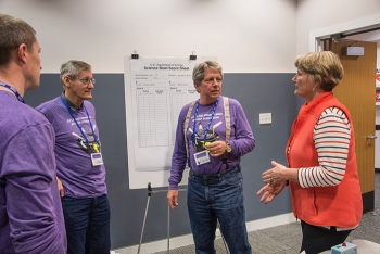 Science Judge Brent Peters (left), scorekeeper Jeff Igel and moderator Dr. Brian Looney (right), discuss with Pamela Marks how the double elimination rounds are conducted during the recent Savannah River Science Bowl competition held in Aiken, S.C.