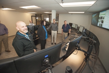 Mission Support Alliance President Bob Wilkinson and Chief Operations Officer Amy Basche tour the Network Operations Center to view the new layout and design.