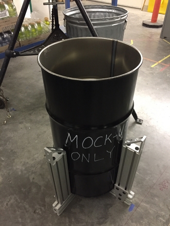 A view of a 16-gallon drum mockup with a centering device attached to allow insertion of a shielded container into a 55-gallon drum.