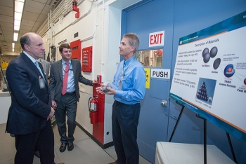 Savannah River National Laboratory Senior Fellow Scientist Bob Pierce (right) explains the research he is conducting for processing graphite fuel to Under Secretary for Science Paul Dabbar (left) and Taylor Playforth of DOE Congressional Affairs.