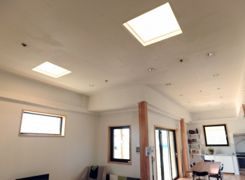 Photo of a home showing windows, skylights, and sliding glass doors.