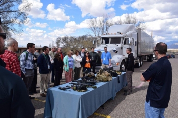 An OST convoy commander explains equipment used by Federal Agents during convoy operations for participants in the NNSA 1st Year program session in Albuquerque.