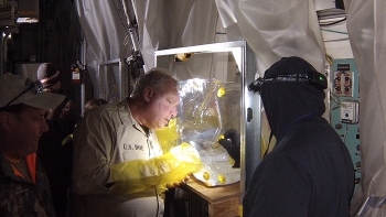 Crews conduct a process known as âfoggingâ to blow a fixative material into contaminated hot cells and laboratories to encapsulate and immobilize radioactive contamination.
