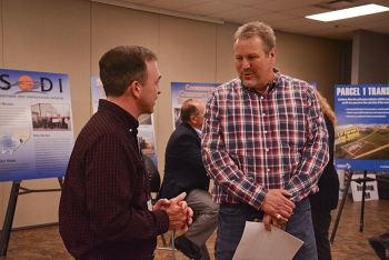 Dr. Jason Lovins with deactivation and decommissioning contractor Fluor-BWXT (left) discusses future use of EMâs Portsmouth Site with Portsmouth Mayor Kevin Johnson last week at a community open house in Scioto County, Ohio