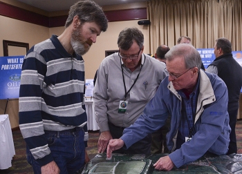 WKKJ Radioâs Kevin Coleman (left) discusses the Portsmouth On-Site Waste Disposal Facility project with EMâs Jud Lilly (center) and Johnny Reising at the community open house last week in Chillicothe, Ohio.