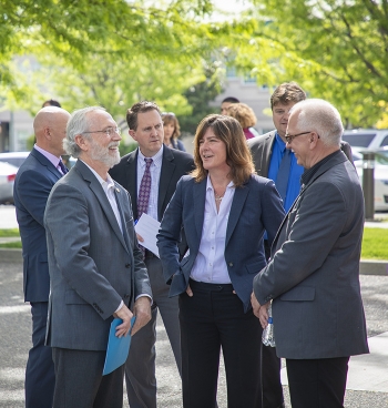 EM Assistant Secretary Anne White (center) talks with Rep. Dan Newhouse (left) and EM Richland Operations Office Manager Doug Shoop at the grand opening ceremony of the Hanford Workforce Engagement Center May 3 in Richland, Wash.