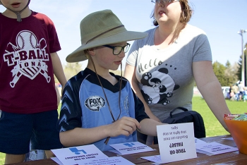 Trent Armstrong takes a quiz on clean transportation at the Fluor Idaho bicycle booth at Earth Day.
