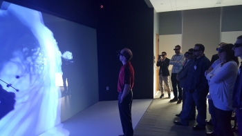 Technology Days participants explore an interactive, 3D visualization of wind patterns in NRELâs Energy System Integration Facility Insight Center.