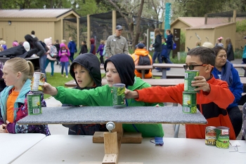 Students work with one of several simple machines on display at Fluor Idaho's learning station.