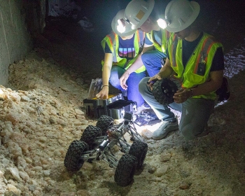 Area high school students prepare a robot for testing in the Waste Isolation Pilot Plant underground in early May, prior to an international robotics competition.