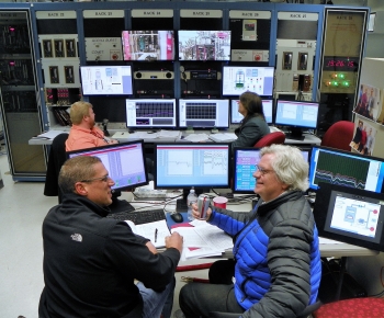 KRUSTY control room during the full-power run, Marc Gibson (GRC/NASA) and David Poston (LANL/NNSA) in foreground, Geordie McKenzie (LANL/NNSA) and Joetta Goda (LANL/NNSA) in background.