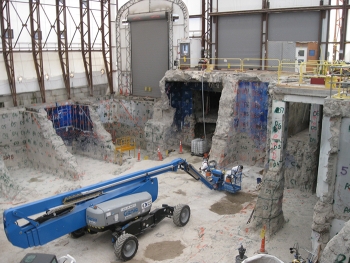 Under a tented enclosure, workers cleaned out the interior of Building H2.