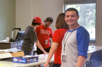 Undergraduate students set up a fuel cell car activity at UNM