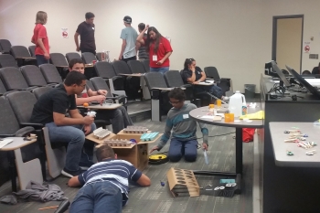 Middle schoolers get down to business during a Build Your Village activity