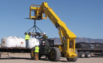 Excavated soil is sealed within Department of Transportation-certified Industrial Packaging and loaded onto trucks at the Clean Slate II site.